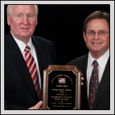 Legislative Award—Alamance County Farm Bureau President Vaughn Willoughby receives the award from NCFB President Larry Wooten (right).