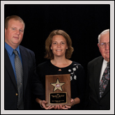 Excellence in Agriculture Award—Kevin and Julie Roberts, of Perquimans County Farm Bureau, receive the award from NCFB Vice President J.M. Wright Jr. (right).